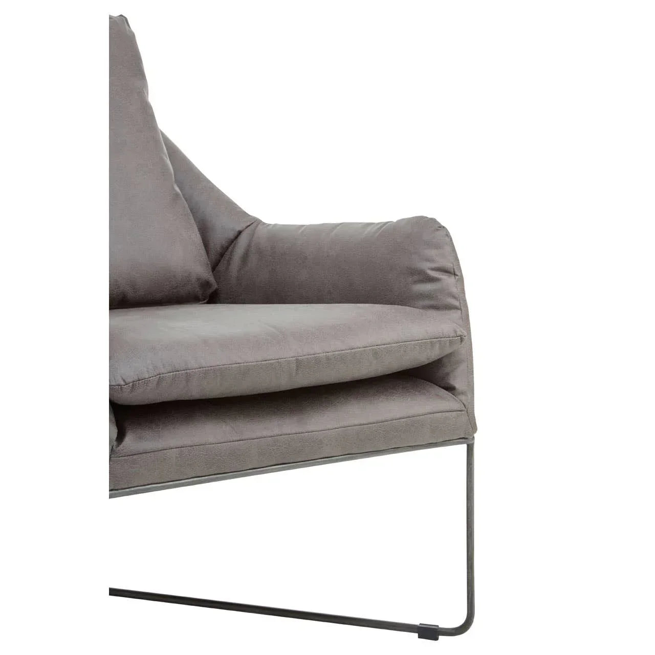 Grey velvet armchair with metal frame and plush cushions, close side view