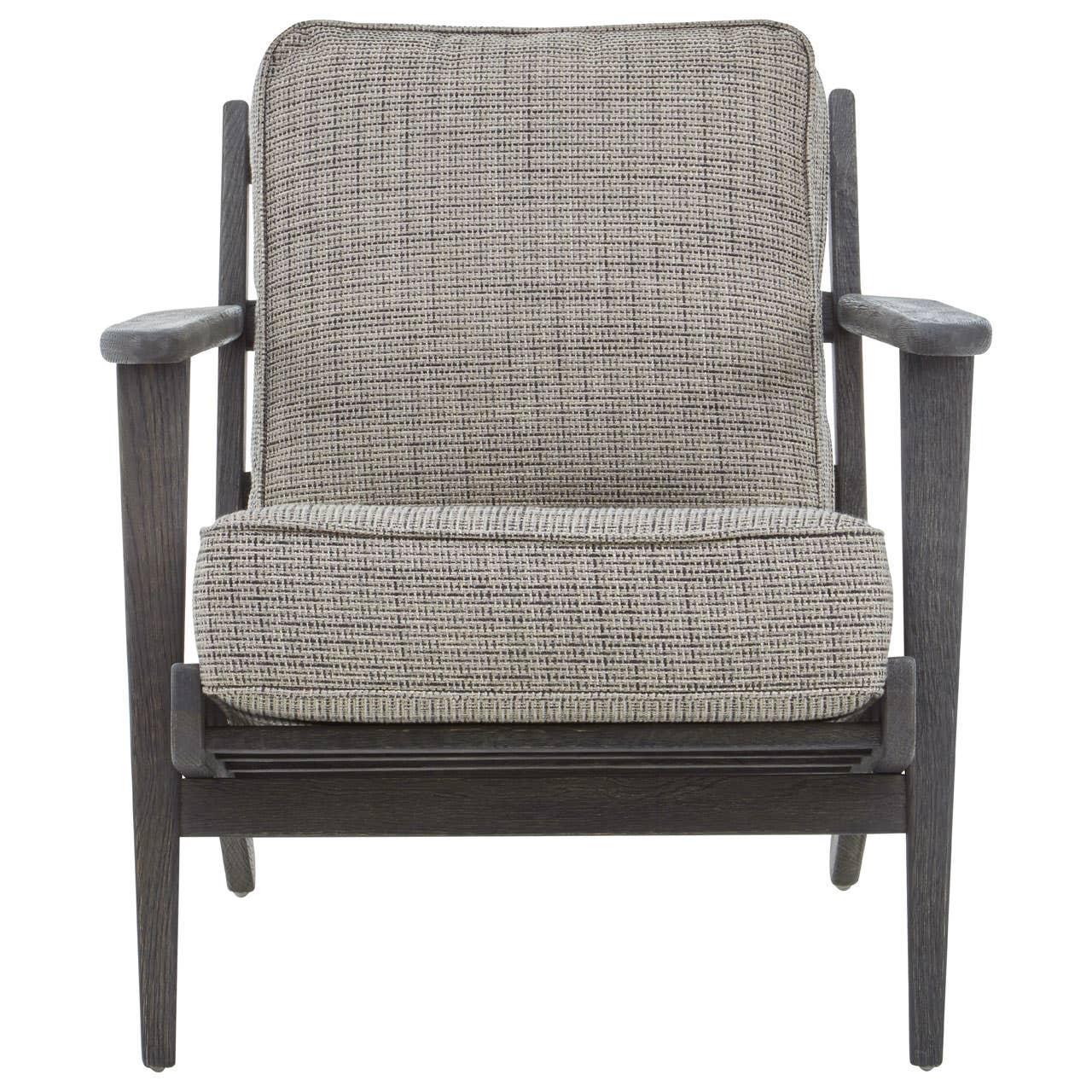 Modern accent chair with grey upholstered seat and dark wooden arms, front view