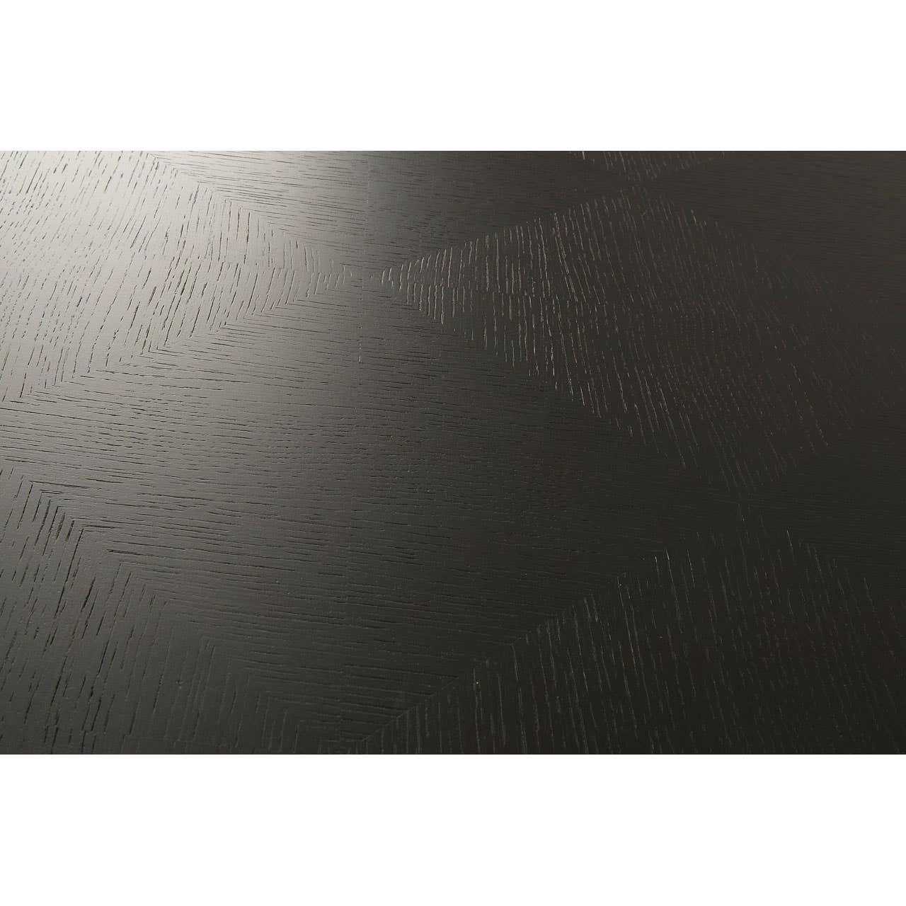 Close-up of dark wood dining table top with geometric grain pattern