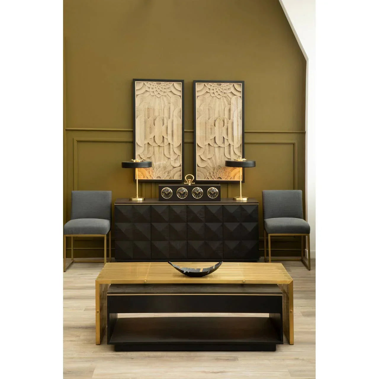 Black geometric sideboard with gold lamps, decorative wall art, and modern coffee table