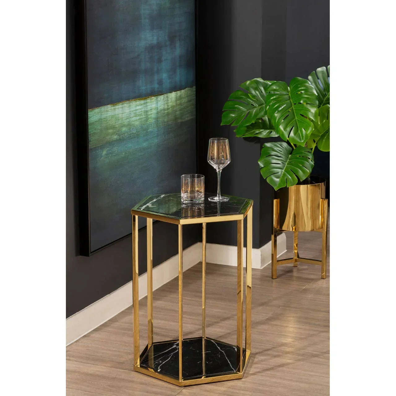 Hexagonal marble and gold side table with glassware in modern living room setting