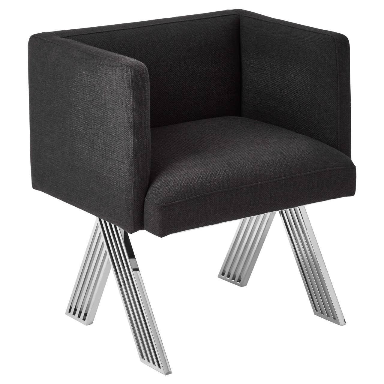 Black upholstered armchair with chrome legs and boxy silhouette