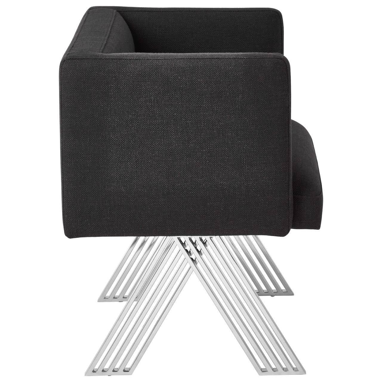 Side view of black armchair with chrome metal legs and boxy silhouette