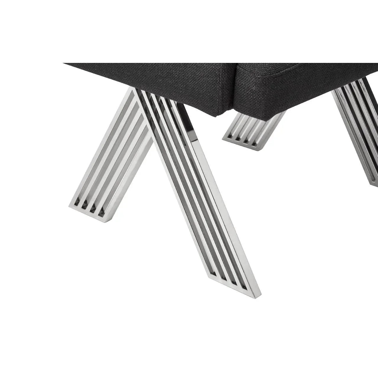 Chrome metal sofa legs with black upholstered seat close up