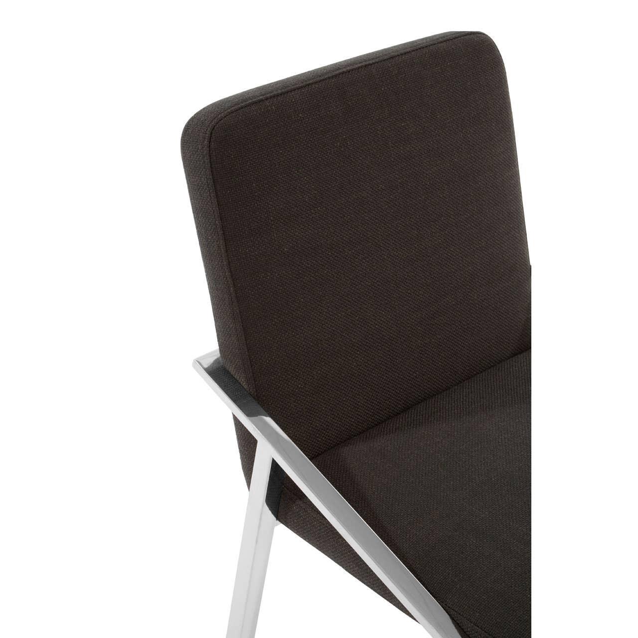 Closeup of black fabric dining chair with angled chrome legs and padded backrest