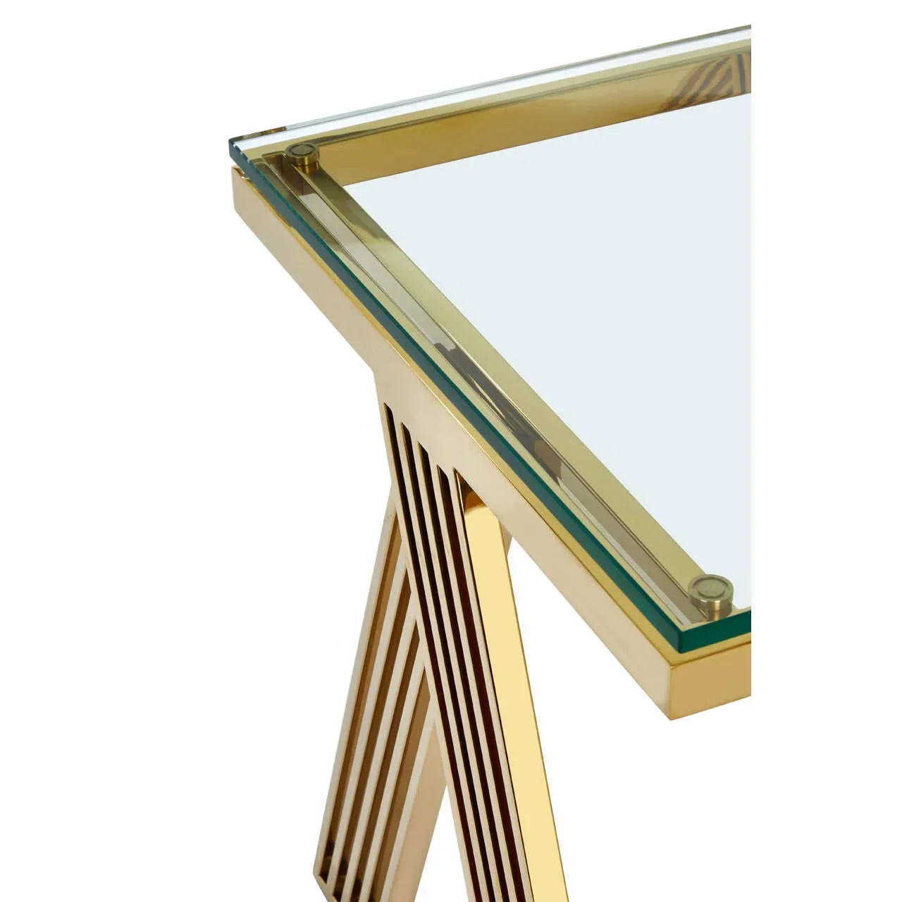 Glass top dining table with gold metal frame and geometric angled leg detail