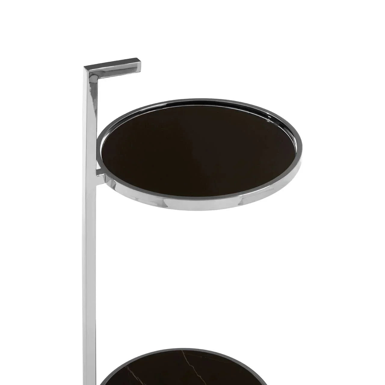 Round black glass side table with chrome frame, partial view showing two tiers