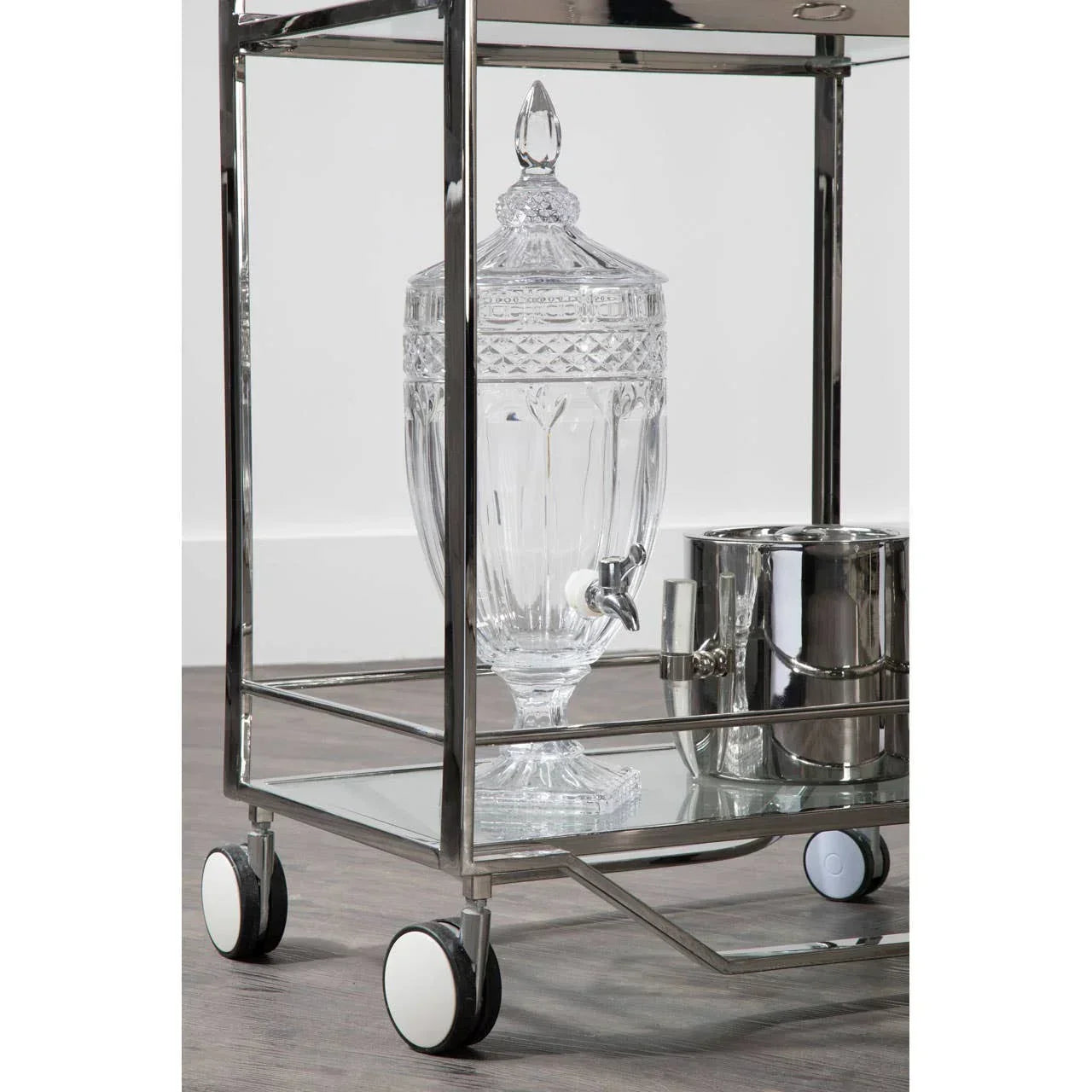 Glass drinks dispenser and stainless steel ice bucket on a chrome bar trolley with wheels