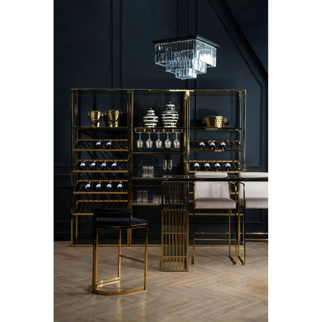 Gold metal bar cabinet with wine racks, glass storage, and matching bar stools in modern room