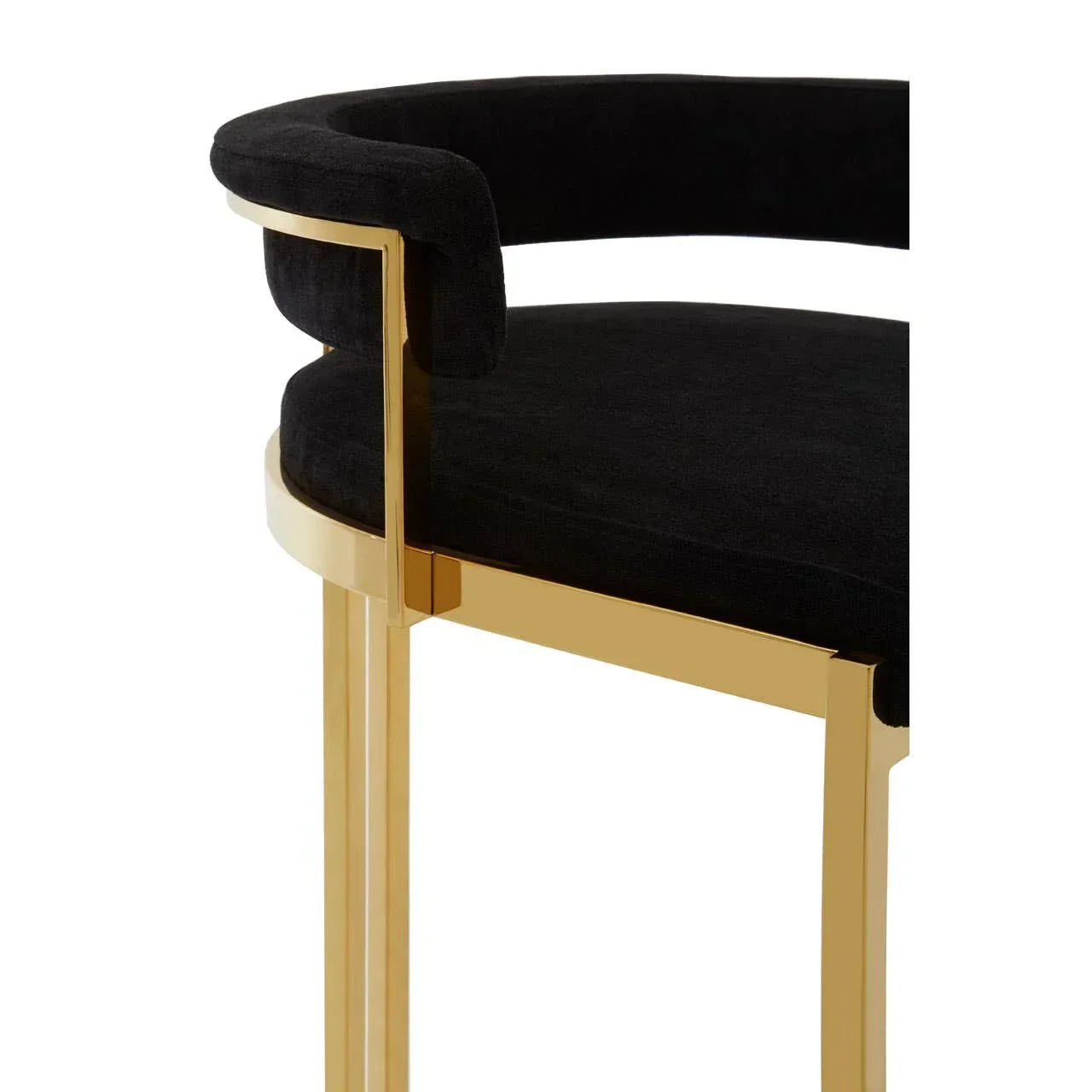 Black velvet dining chair with gold metal frame and curved backrest, side angle view