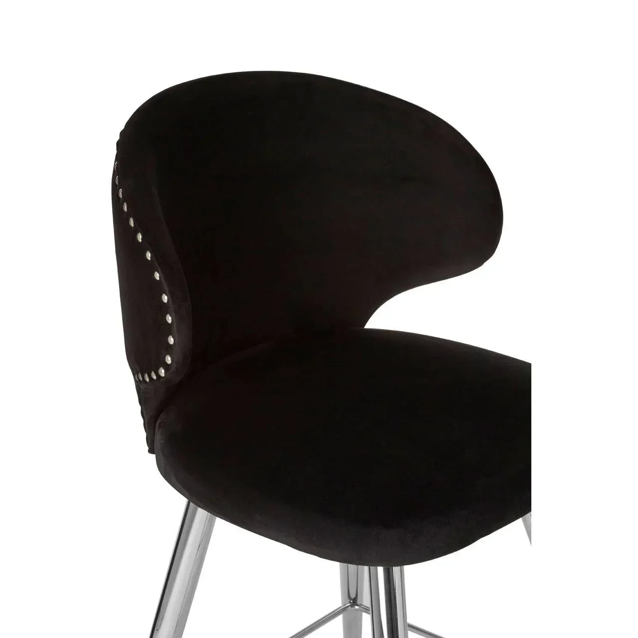 Black velvet dining chair with curved backrest, silver stud detailing, and chrome legs