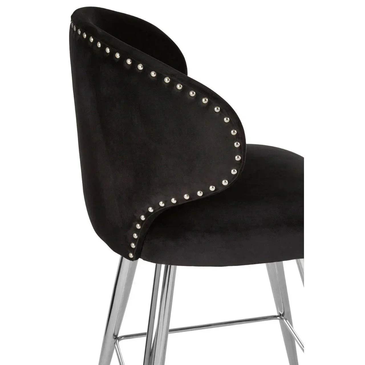 Black velvet dining chair with chrome legs and silver nailhead trim, side angle view