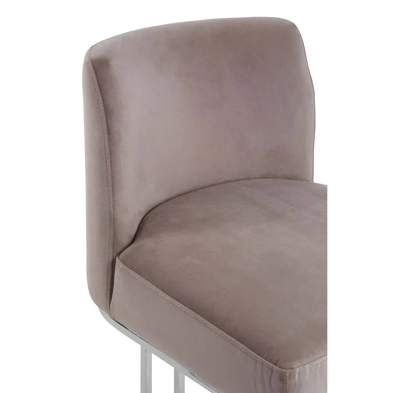 Taupe velvet dining chair with curved backrest and silver metal legs, angled side view