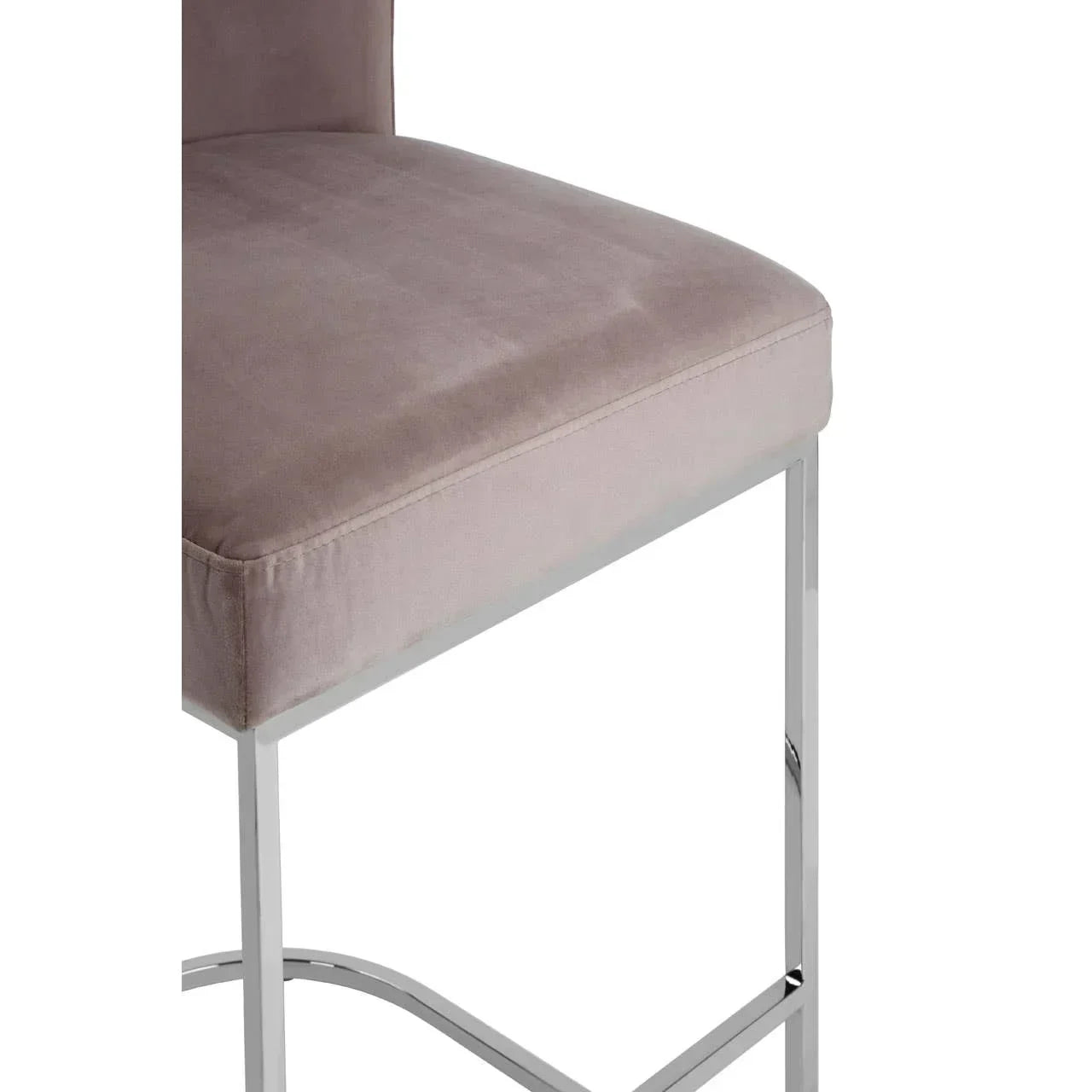 Grey velvet dining chair with chrome metal legs, close-up of cushioned seat and base