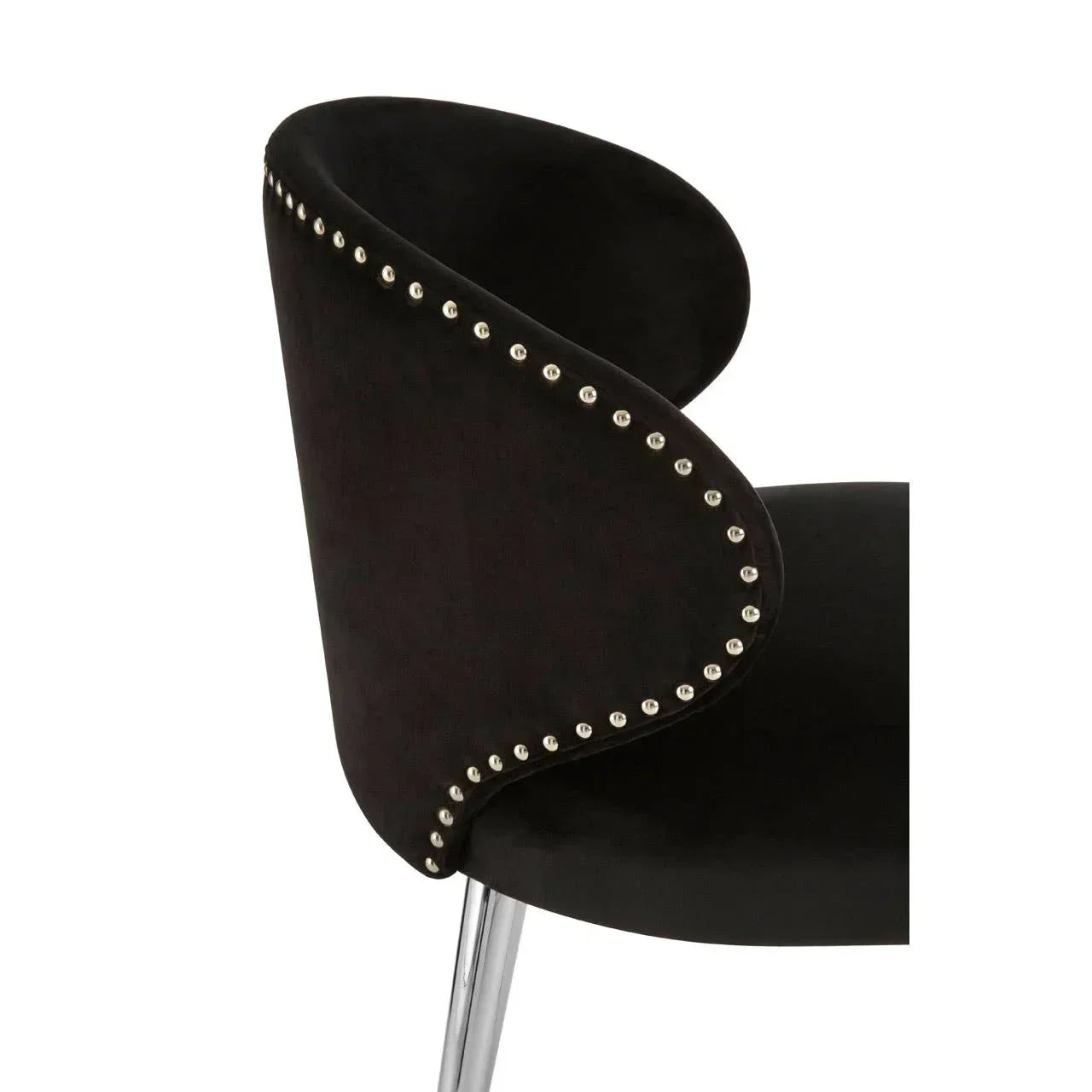 Black velvet dining chair with silver studded trim and chrome legs, side angle view