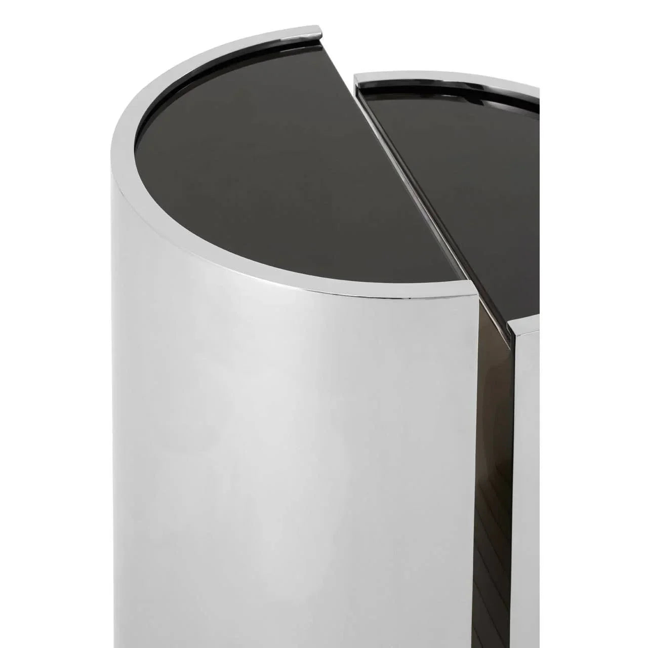 Round mirrored side table with black glass top, modern chrome finish, close-up view