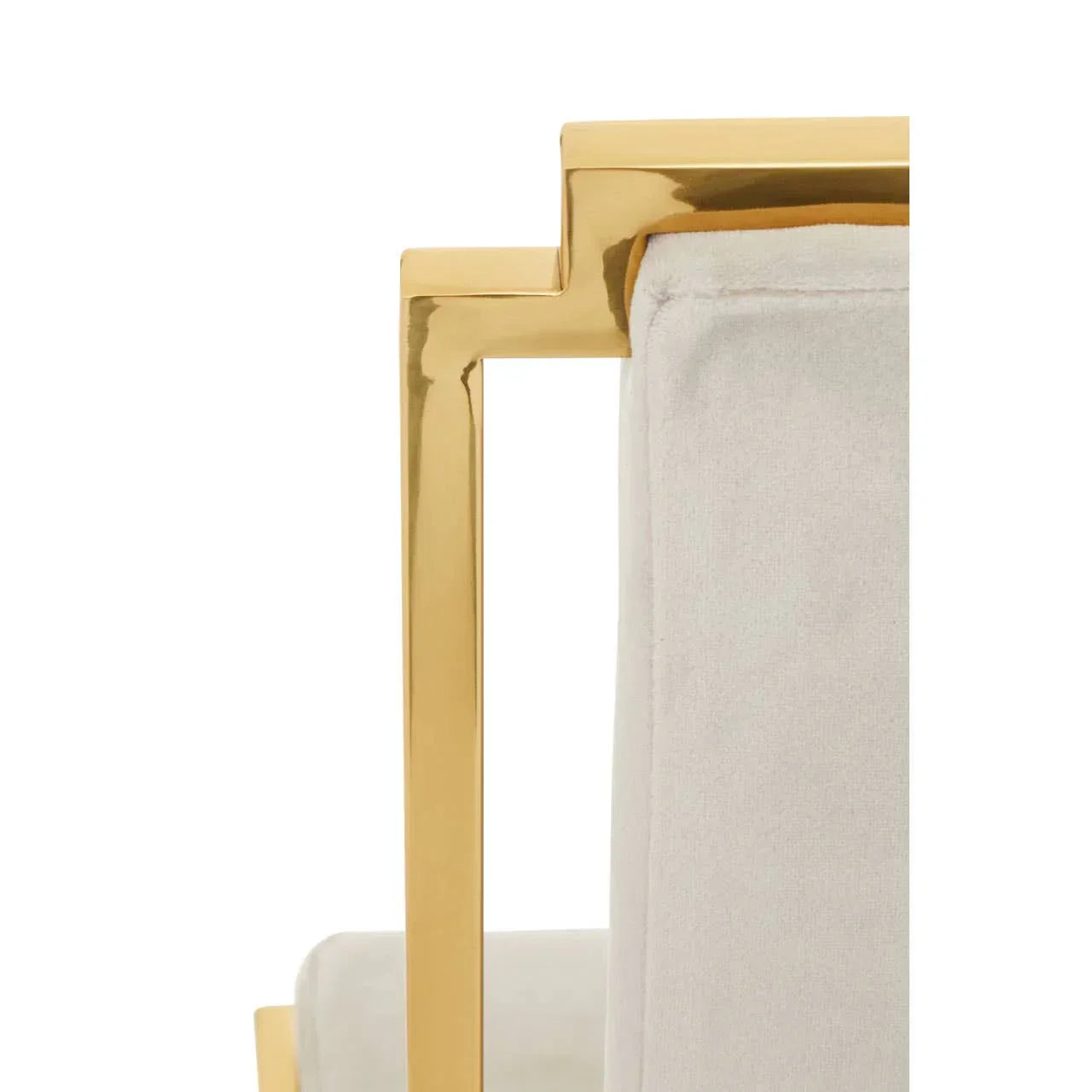 Closeup of gold metal chair arm with light fabric upholstery