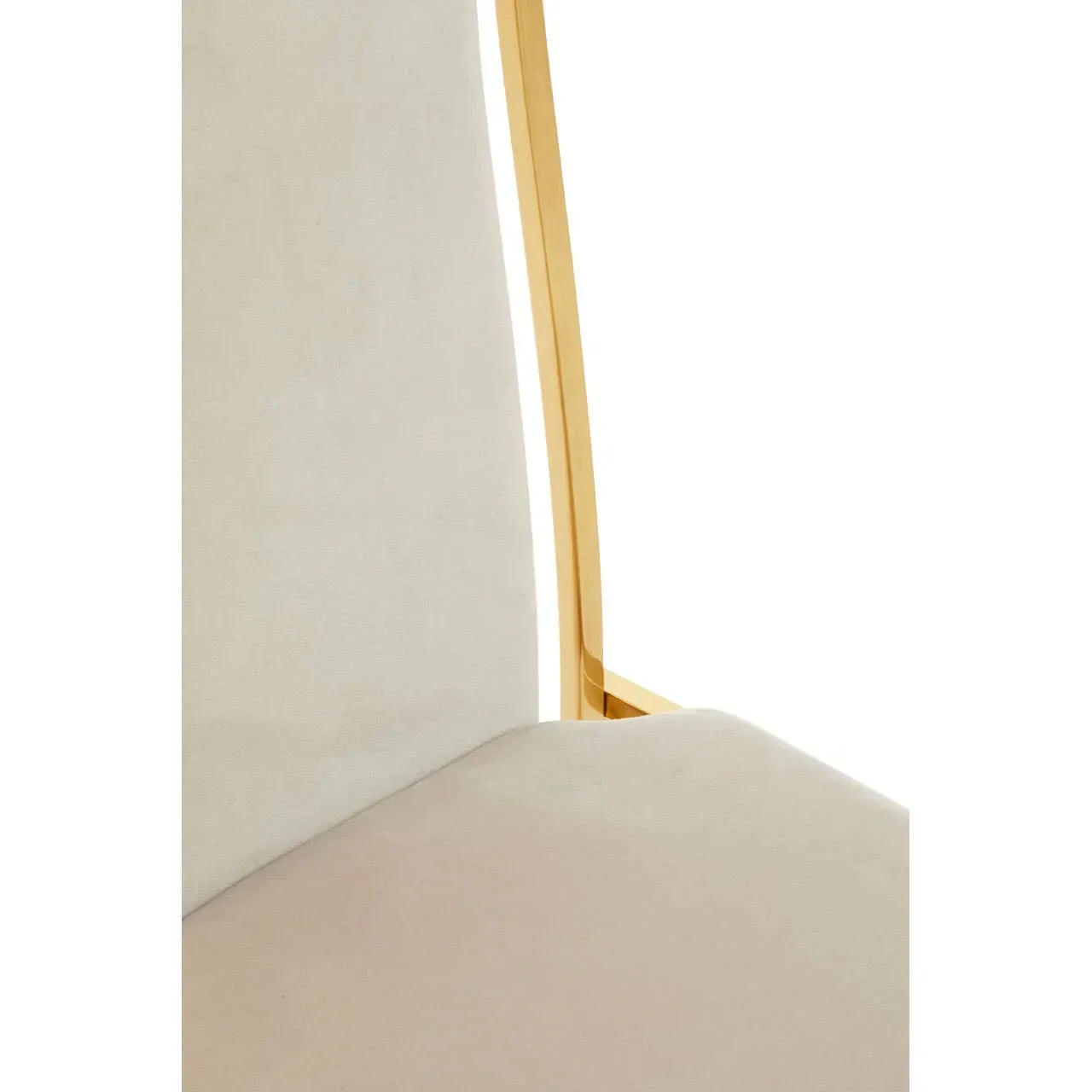 Close view of beige upholstered dining chair with gold metal frame