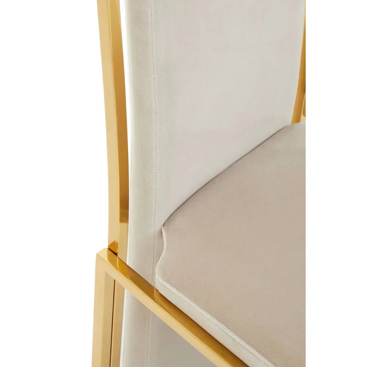 Beige velvet dining chair with gold metal frame closeup