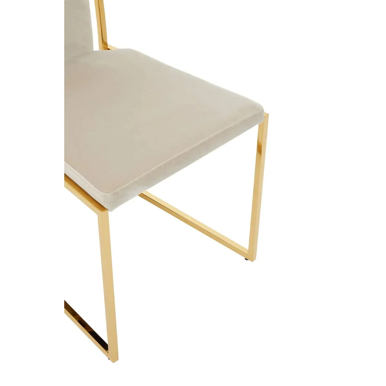 Beige upholstered dining chair with gold metal legs, close-up of seat and frame