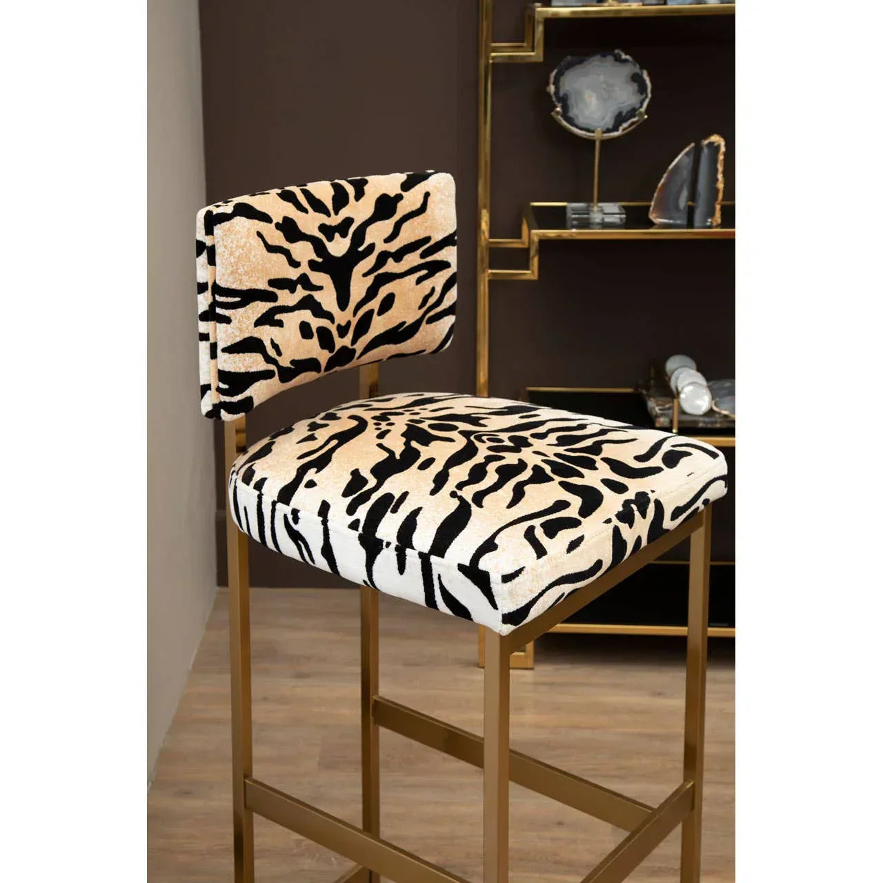 Velvet bar stool with gold frame and animal print upholstery in modern kitchen setting