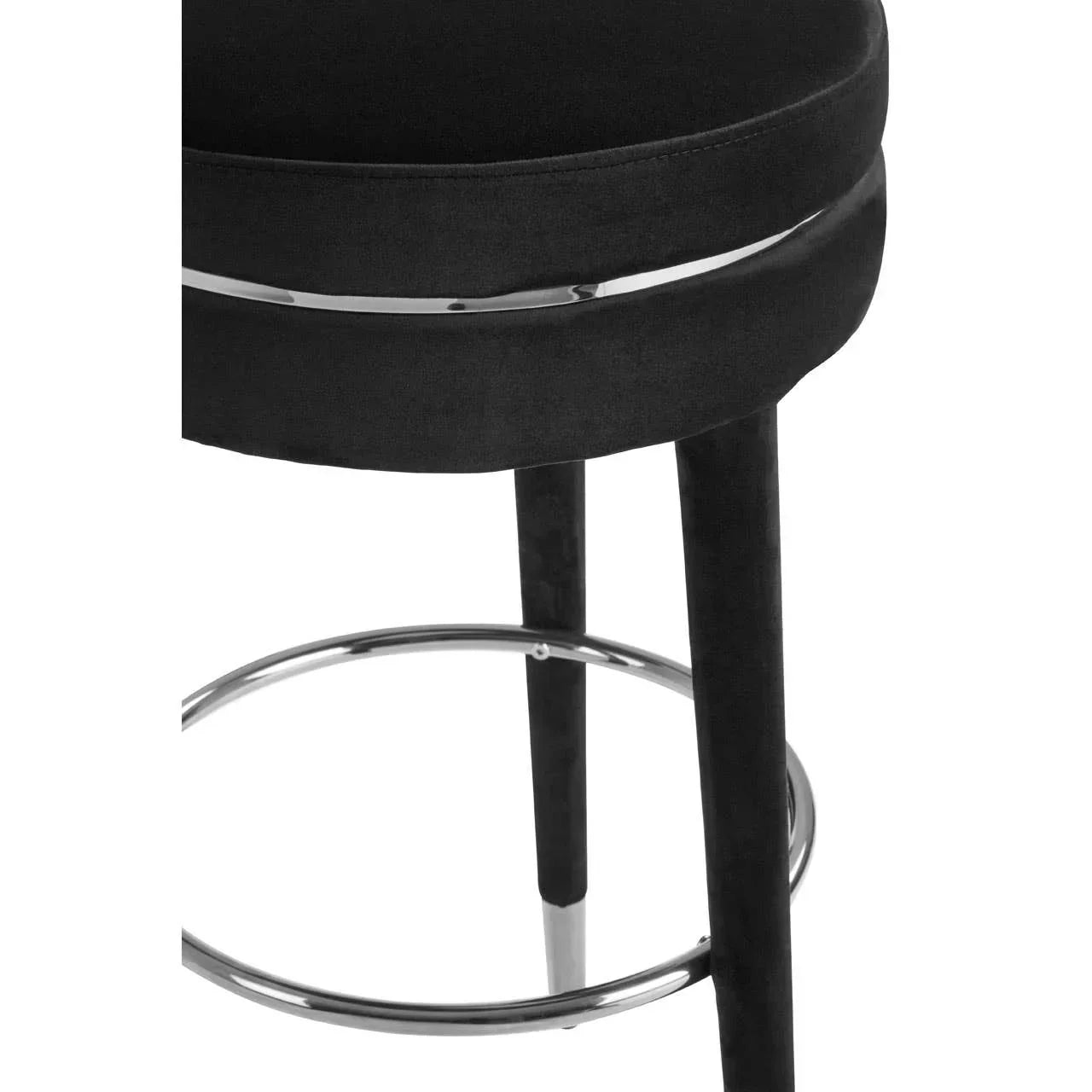 Black velvet bar stool with round chrome footrest and black legs, close-up view