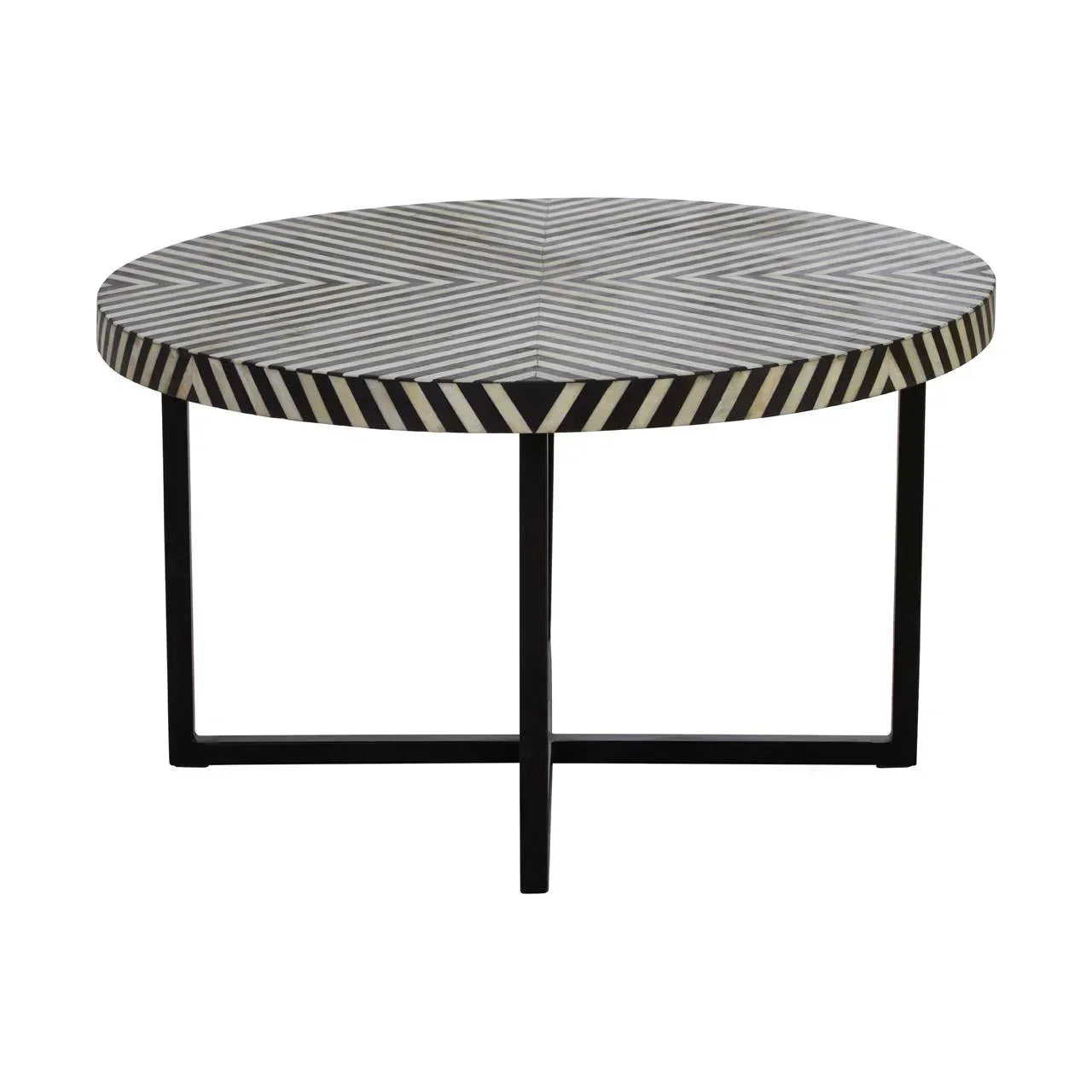 Round coffee table with black and white geometric patterned top and black metal legs