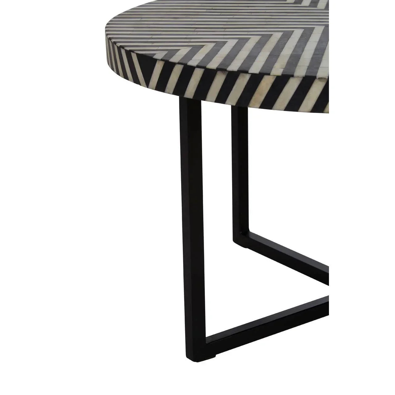 Round coffee table with black and white chevron top and metal frame leg detail
