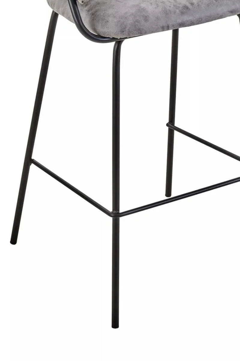 Grey bar stool seat with black metal legs and footrest close-up