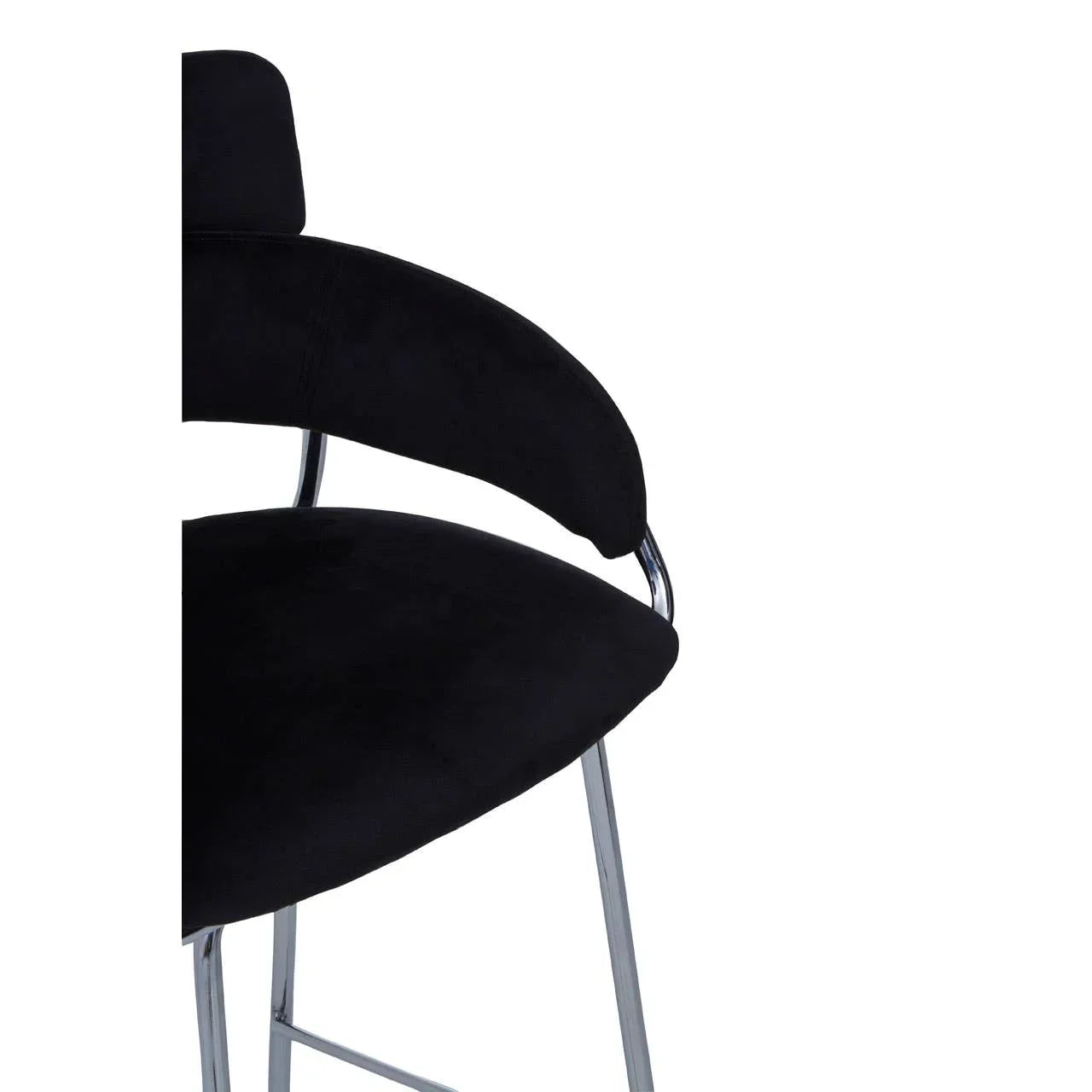 Black velvet bar stool with chrome legs and curved backrest close-up