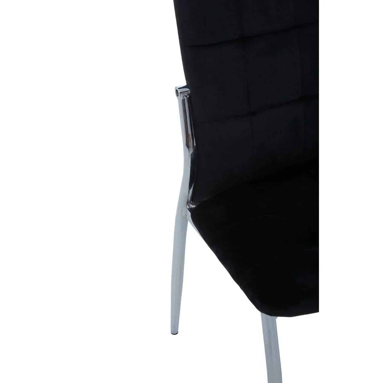 Black velvet dining chair with chrome legs, angled close up of seat and backrest