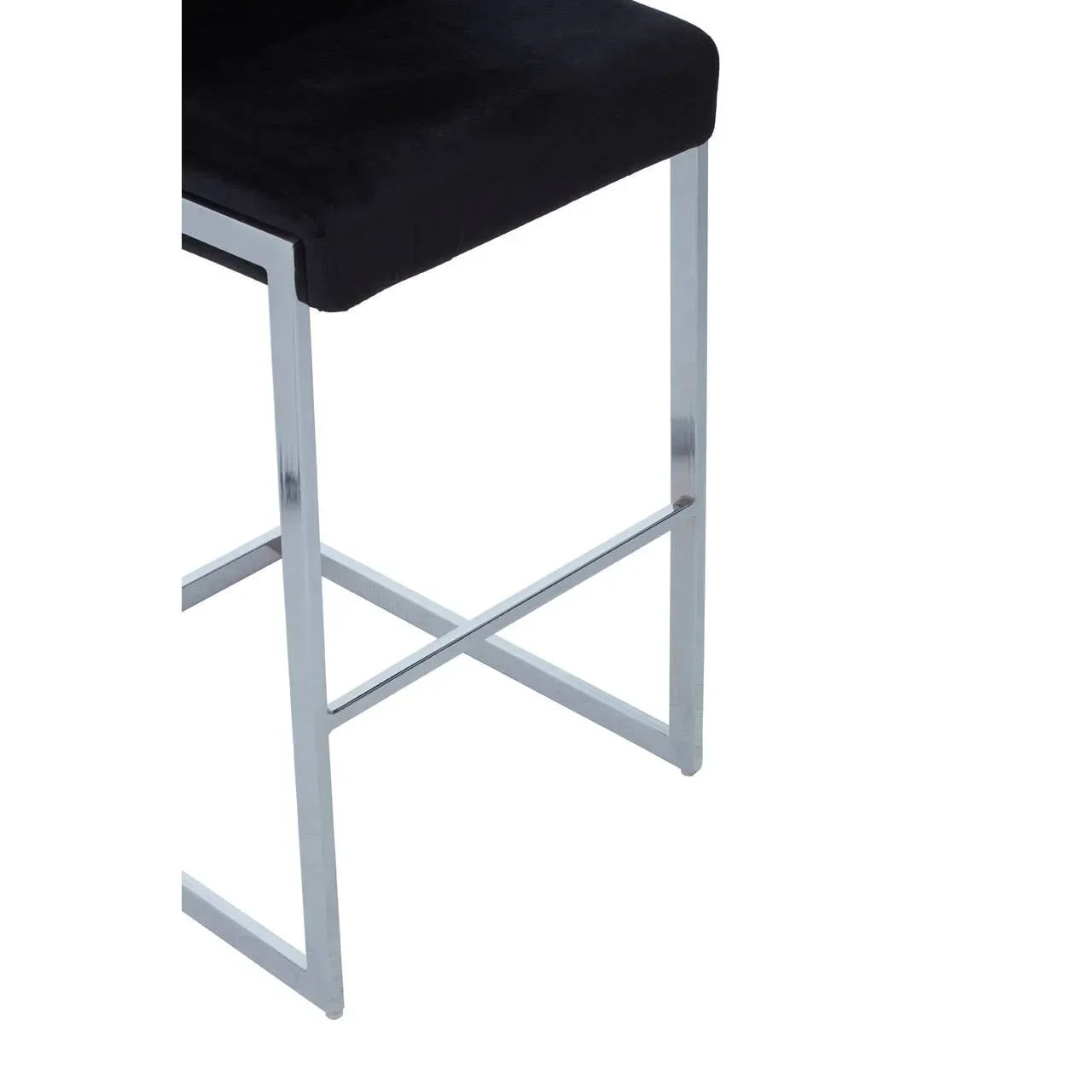 Black velvet bar stool with chrome metal legs and footrest, close up side view