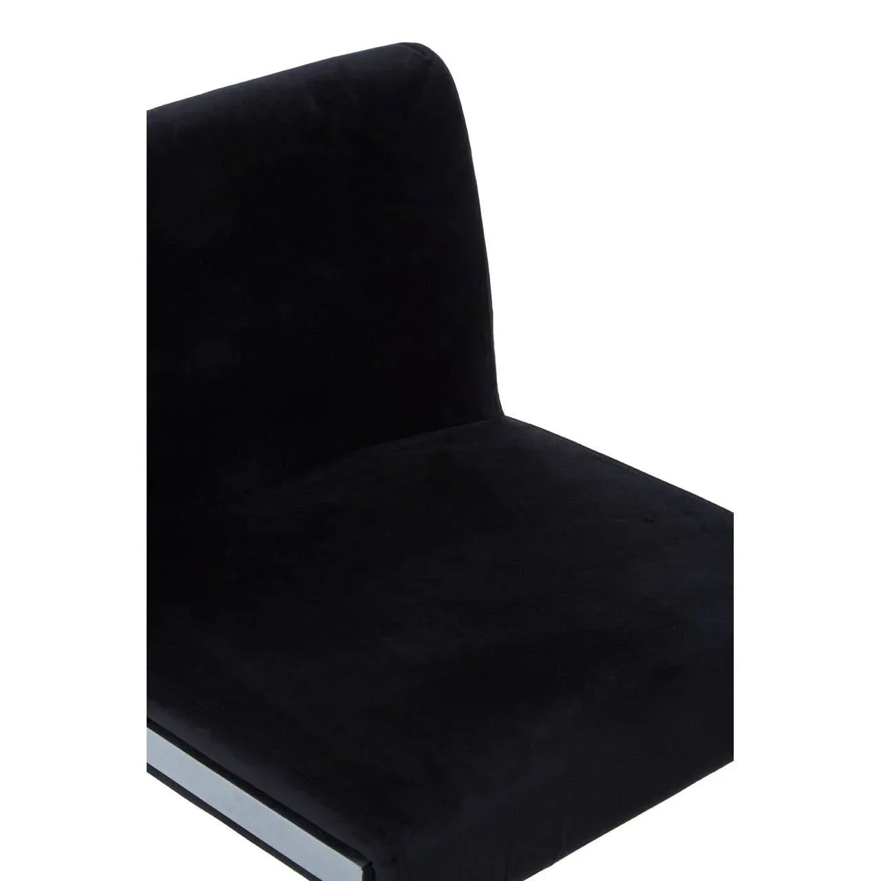 Black velvet dining chair with chrome base, close-up of seat and backrest