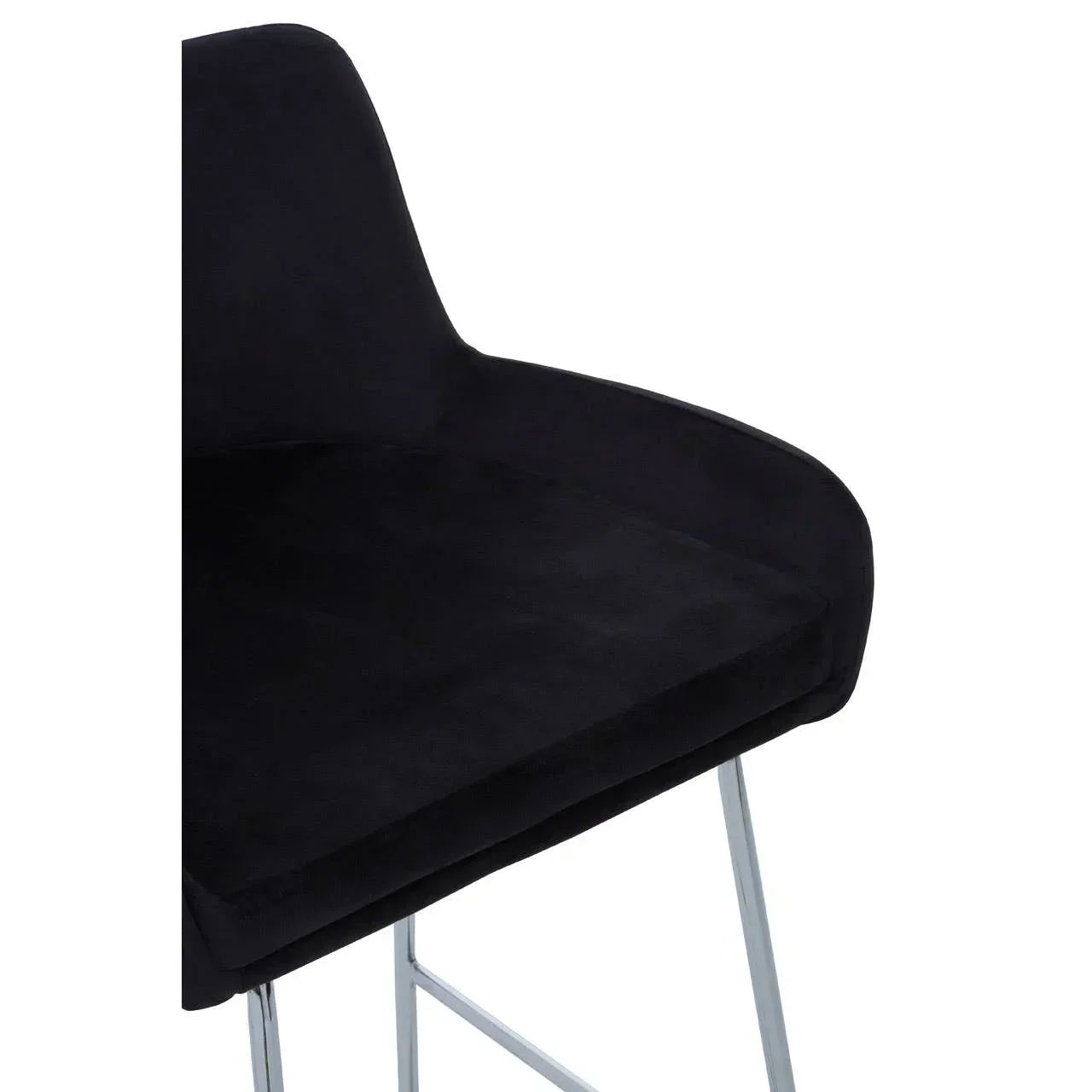Black velvet bar stool seat with padded cushion and chrome legs, side angle view