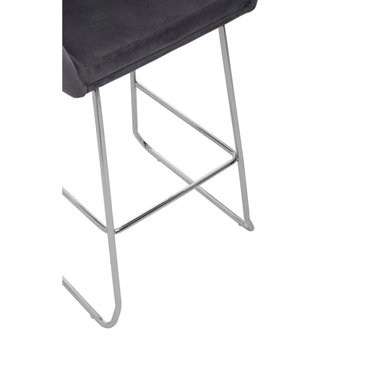 Chrome bar stool legs with footrest and dark seat upholstery close up