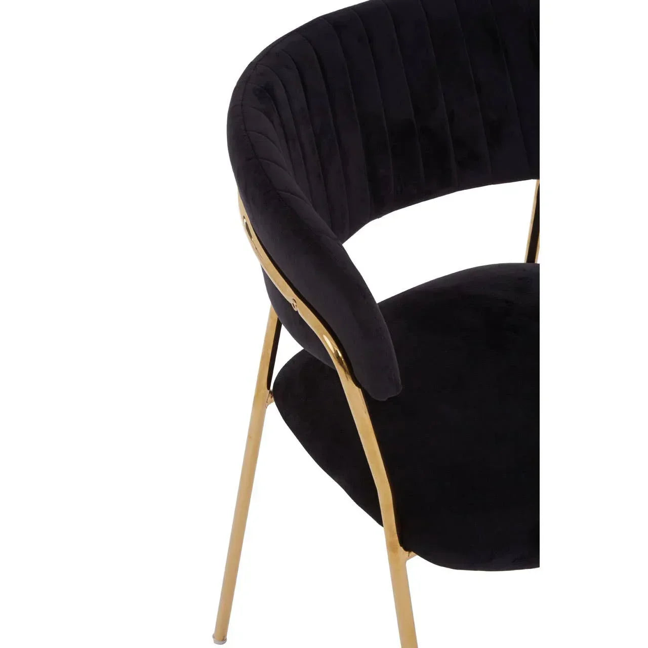 black velvet accent chair with curved back and gold metal legs, partial side view