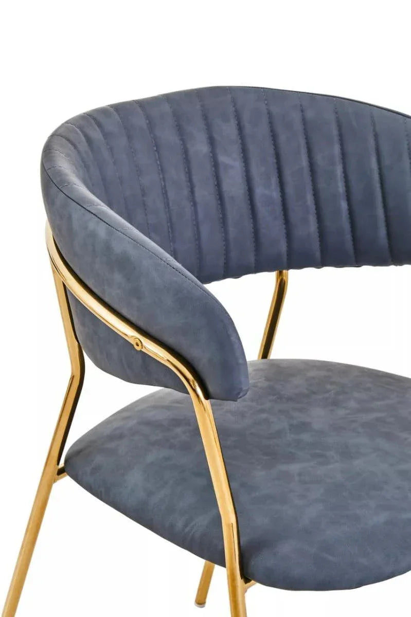 Blue velvet dining chair with gold metal frame and curved backrest
