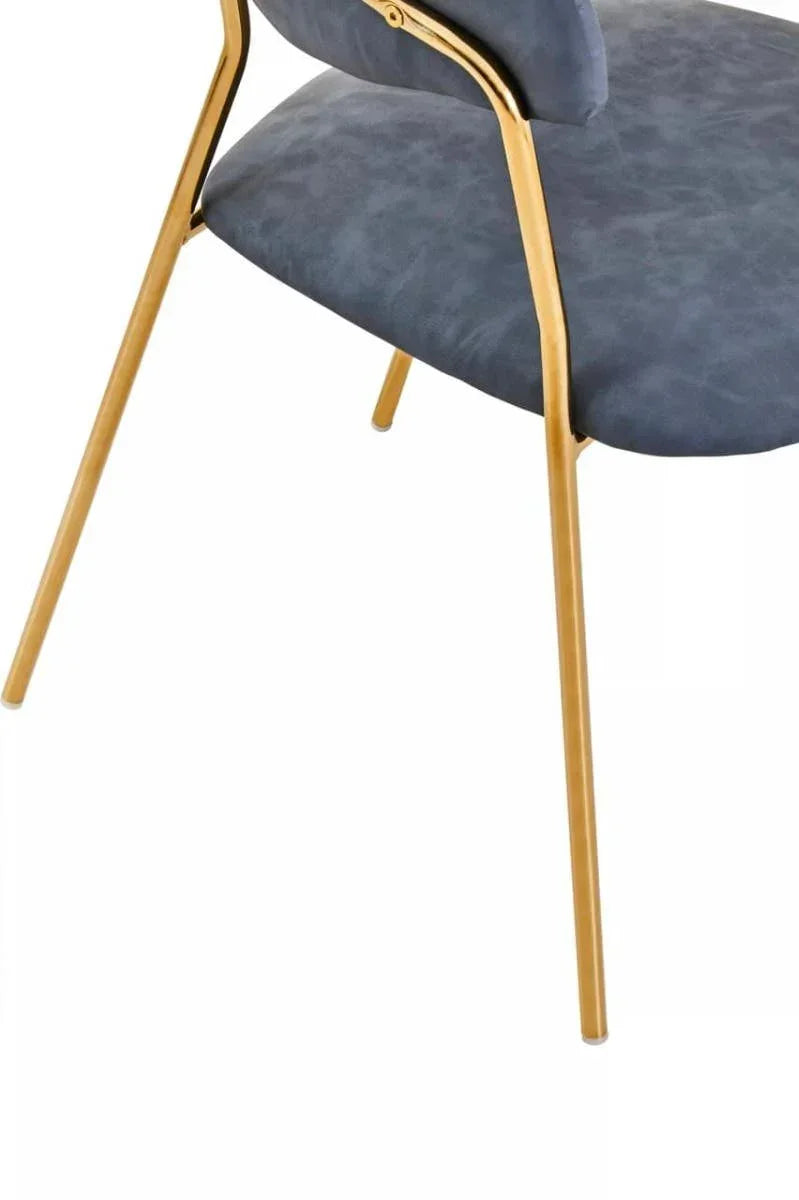 Blue velvet dining chair with gold metal legs, angled view of seat and backrest