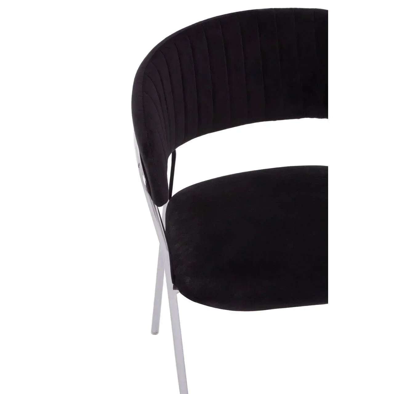 Black velvet dining chair with chrome legs, close view of curved backrest and seat