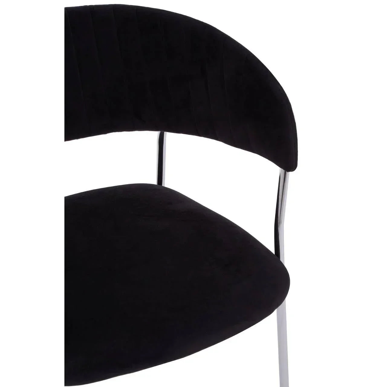 Black velvet dining chair with chrome legs, close view of curved backrest and seat