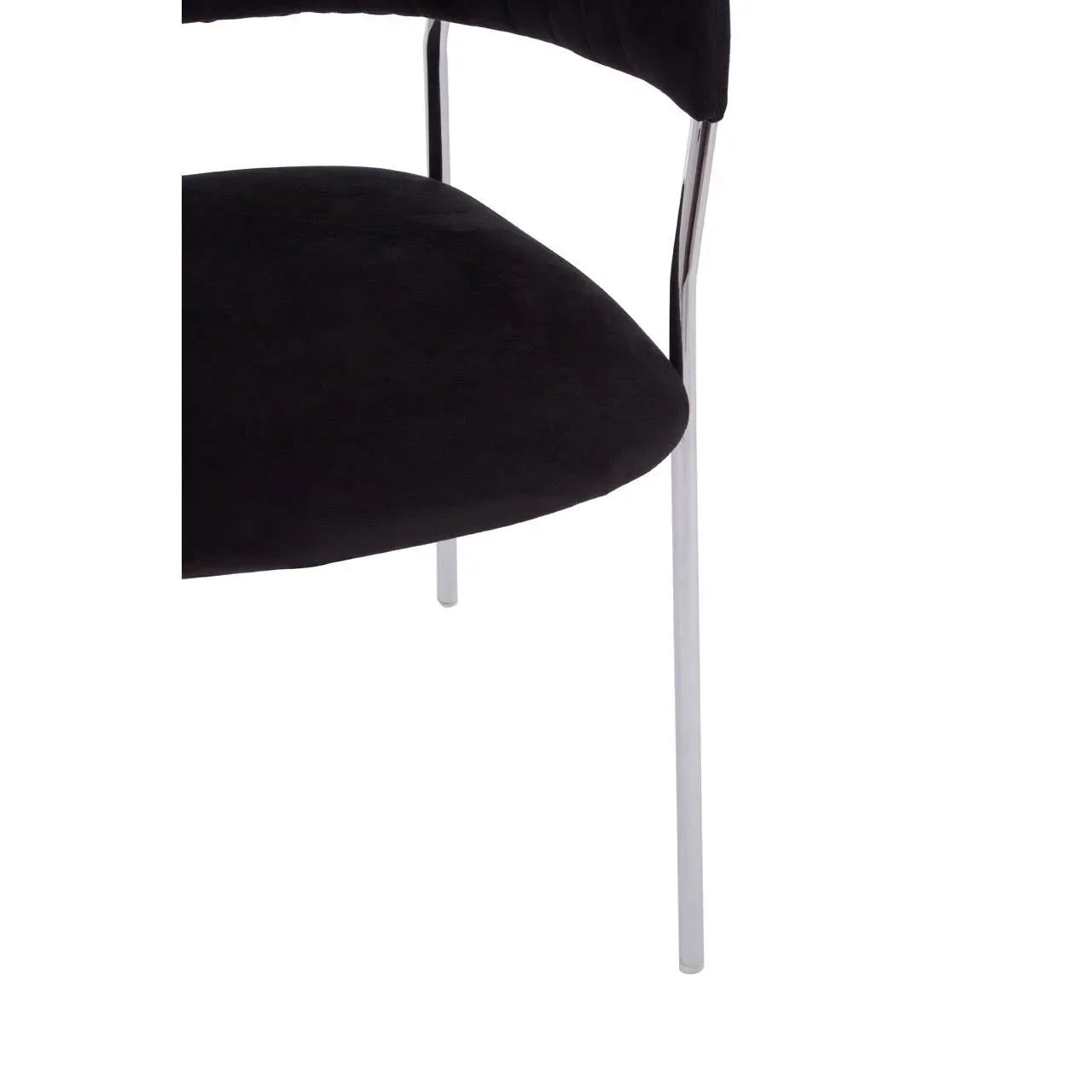 Black velvet dining chair seat with chrome metal leg close-up