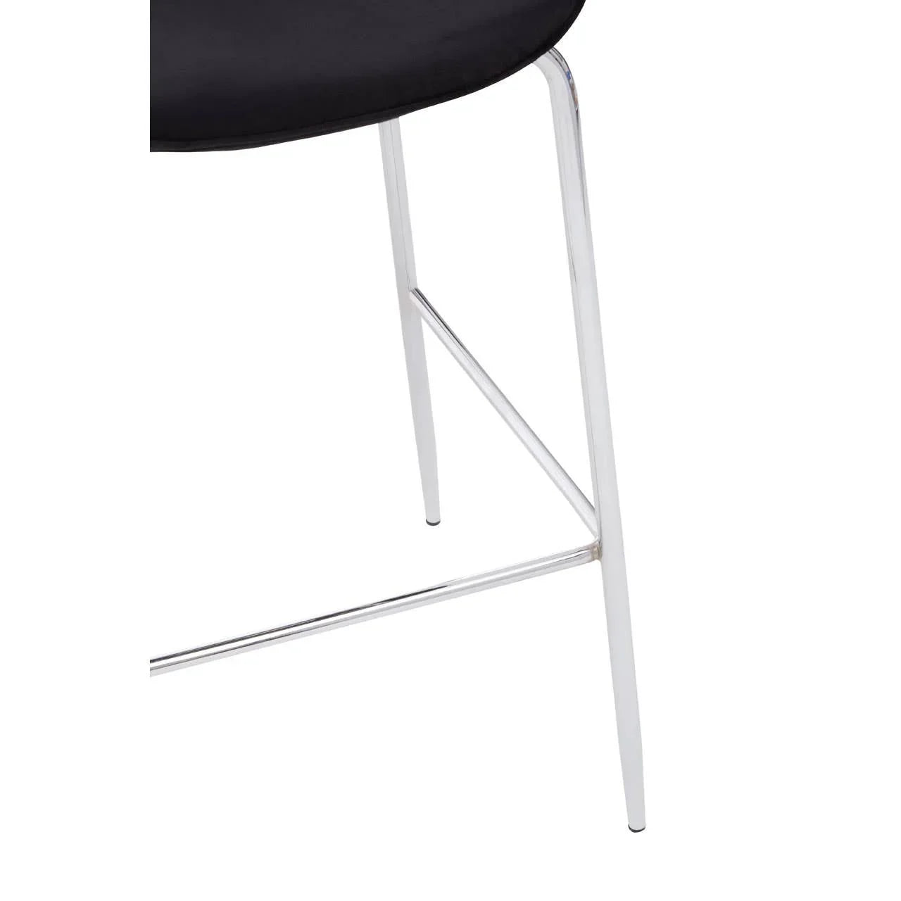 Chrome chair legs with black upholstered seat, modern furniture close-up