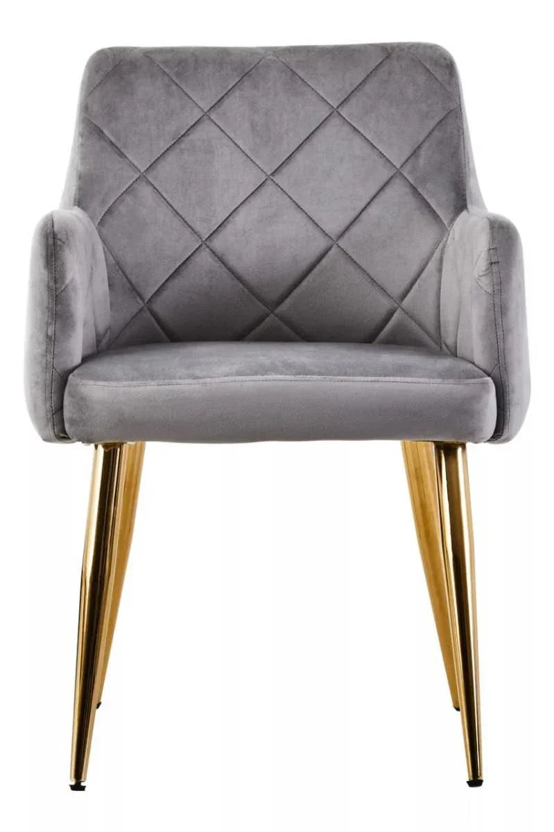 Grey velvet dining chair with diamond stitching and gold metal legs, front view