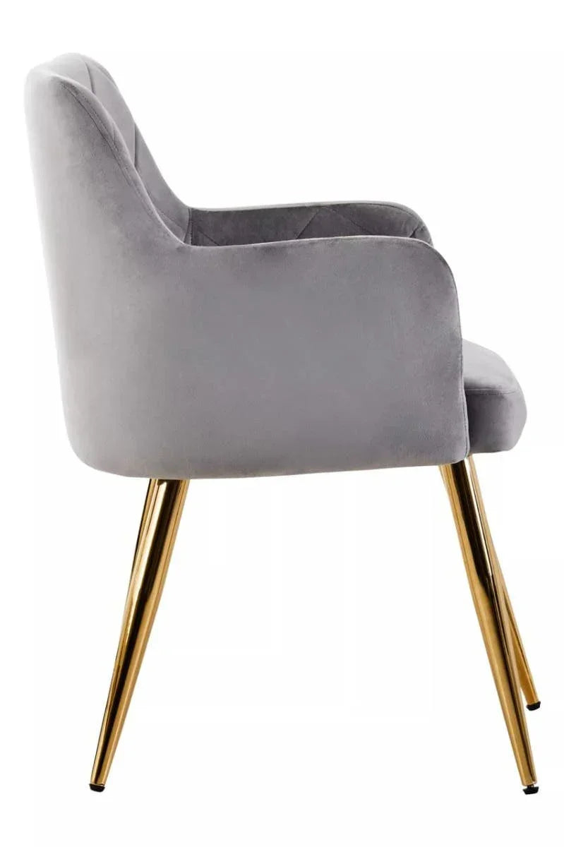 Grey velvet dining chair with gold metal legs, side profile view