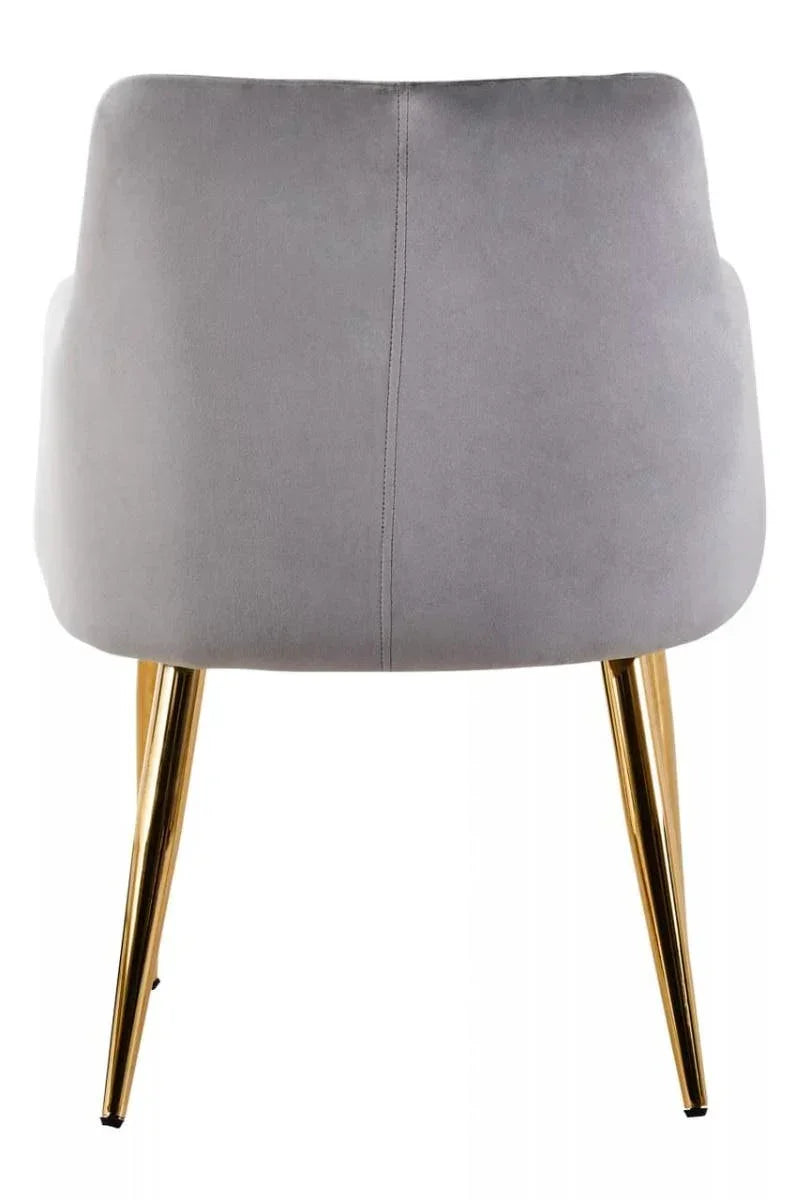 Grey velvet dining chair with gold metal legs, rear view