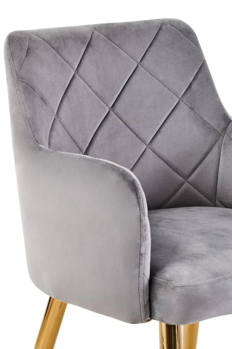 Grey velvet dining chair with quilted backrest and gold metal legs