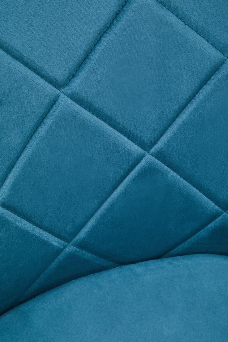 Blue velvet chair upholstery with diamond stitch detail, close-up view