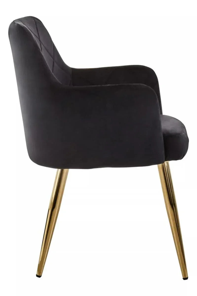 Black velvet dining chair with gold metal legs, side profile view