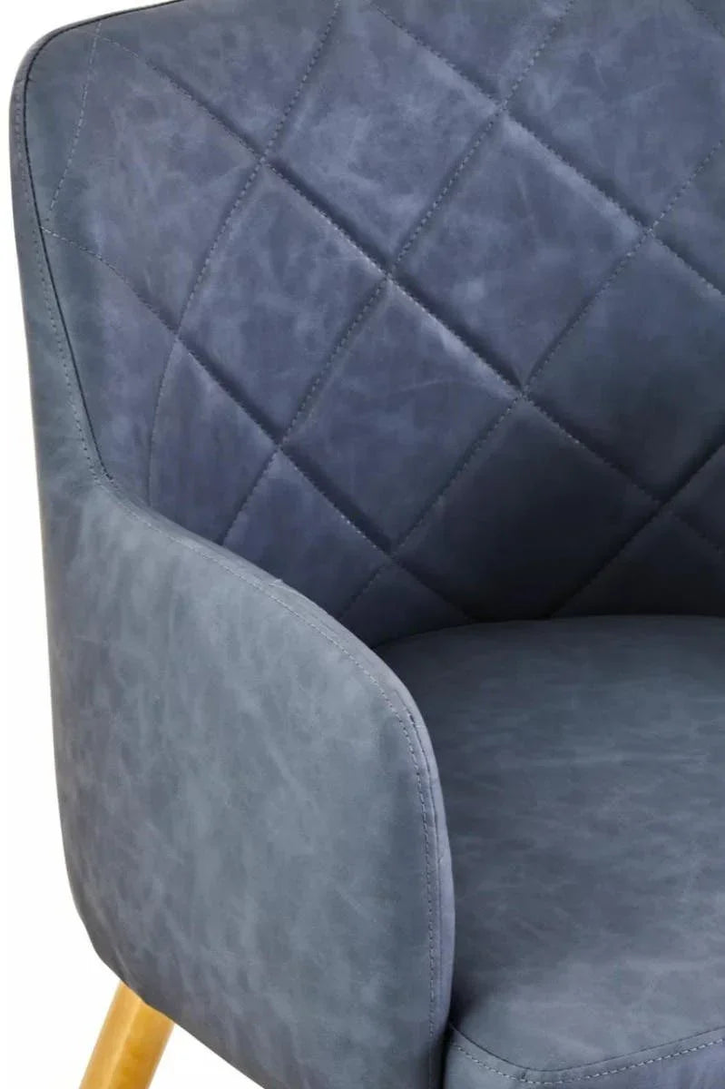 Blue accent chair with quilted backrest and wooden legs closeup