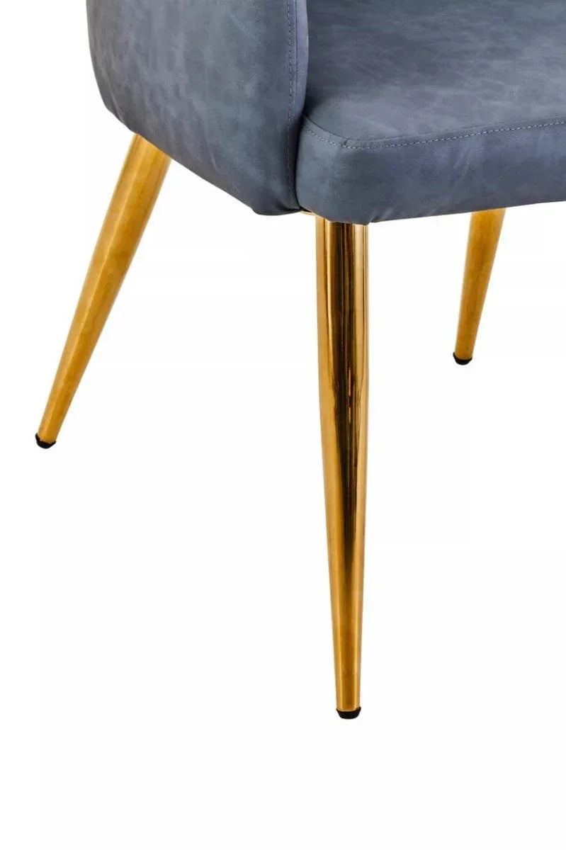 Grey upholstered chair with gold metal legs, close detail of seat and angled legs